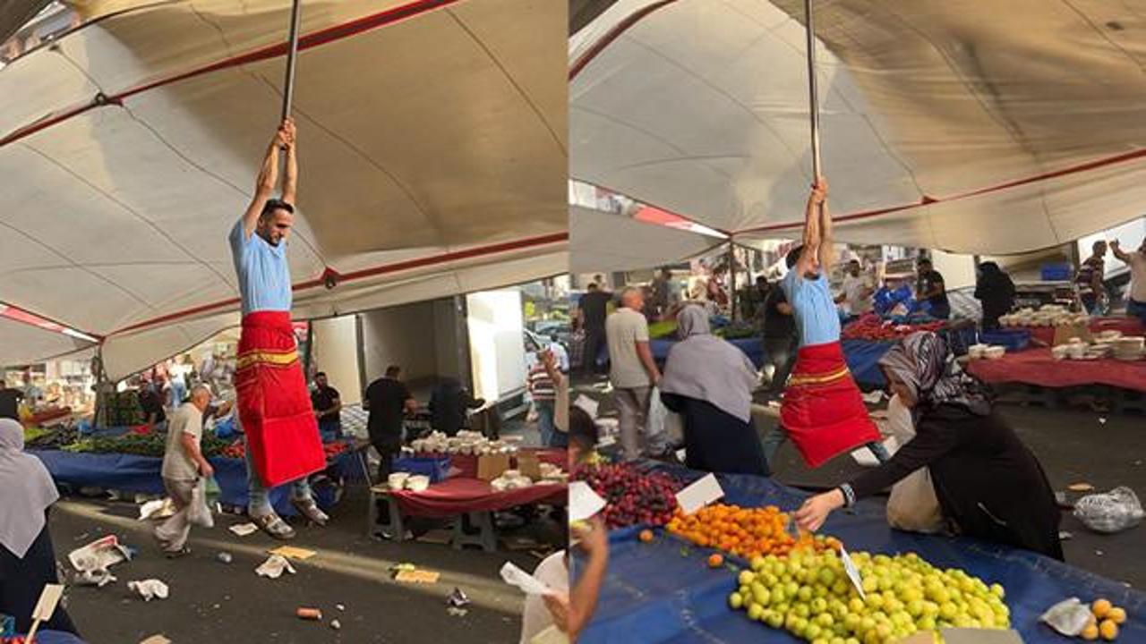 Fırtınada branda direğini bırakmayan pazarcı metrelerce yükseldi